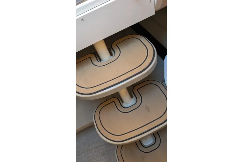Slide: The Image of Staircase detail on 2001 Wellcraft 3300 Martinique boat, featuring wooden steps. - 66