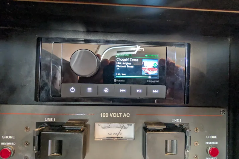 Slide: The Image of Control panel of a 2001 Wellcraft 3300 Martinique boat with audio system display. - 69