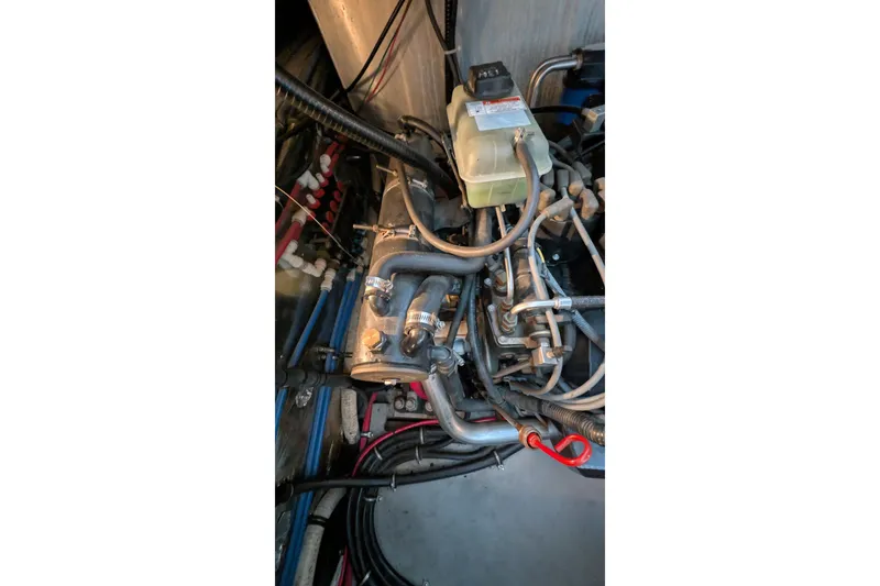Slide: The Image of Engine compartment of a 2001 Wellcraft 3300 Martinique boat, showing hoses and components. - 73