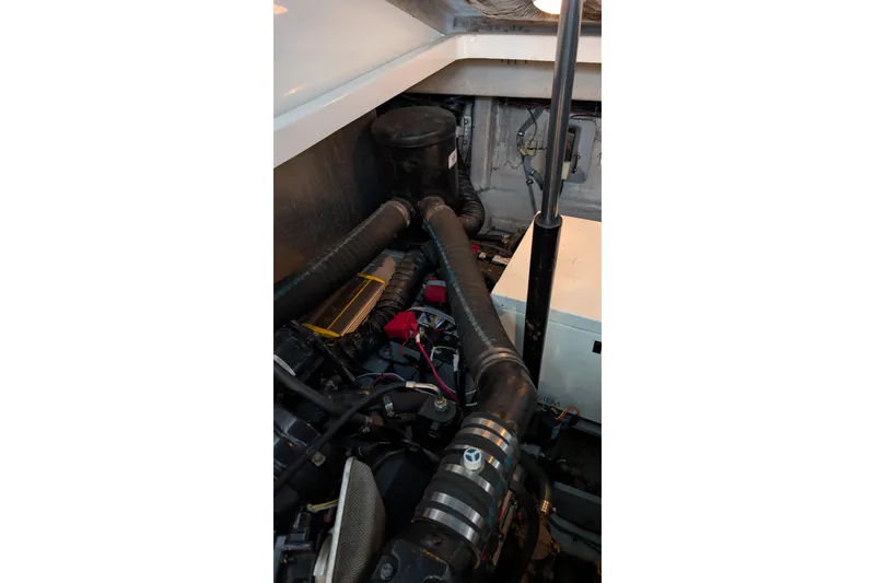 Slide: The Image of Engine compartment of a 2001 Wellcraft 3300 Martinique boat, showing hoses and components. - 75