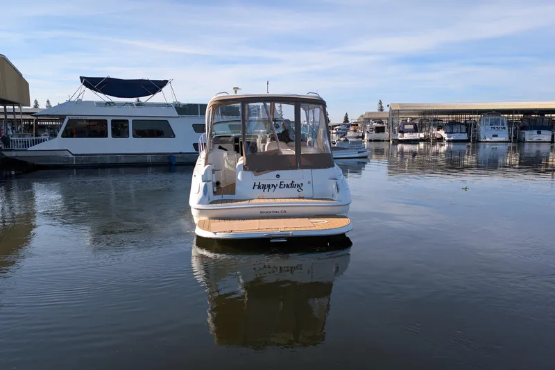 Slide: The Image of 2001 Wellcraft 3300 Martinique boat named "Happy Ending" docked in a marina. - 78