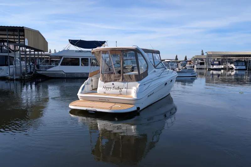 Slide: The Image of 2001 Wellcraft 3300 Martinique boat docked in marina, calm water, clear sky. - 8