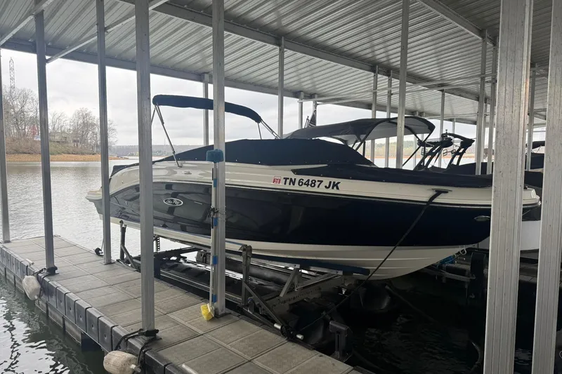 The Image of 2020 Sea Ray SPX 230 boat docked in a covered marina. - 1