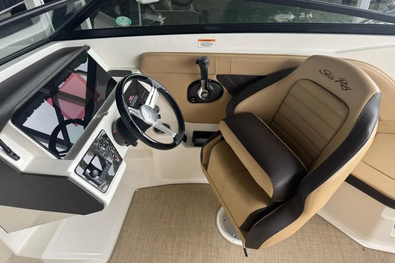 Slide: The Image of 2020 Sea Ray SPX 230 boat interior with steering wheel and captain's seat. - 3