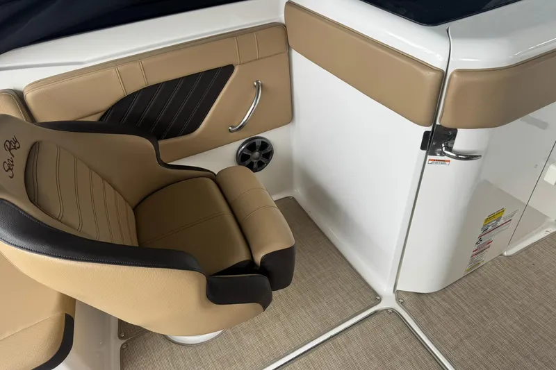 Slide: The Image of 2020 Sea Ray SPX 230 interior with tan and black seating, sleek design. - 5