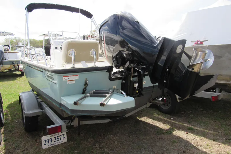 Slide: The Image of 2023 Boston Whaler 170 Montauk boat on trailer, rear view with outboard motor. - 15