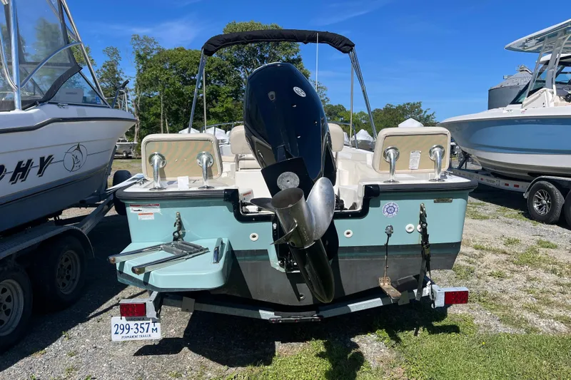 Slide: The Image of 2023 Boston Whaler 170 Montauk boat, rear view with motor, parked on trailer. - 16