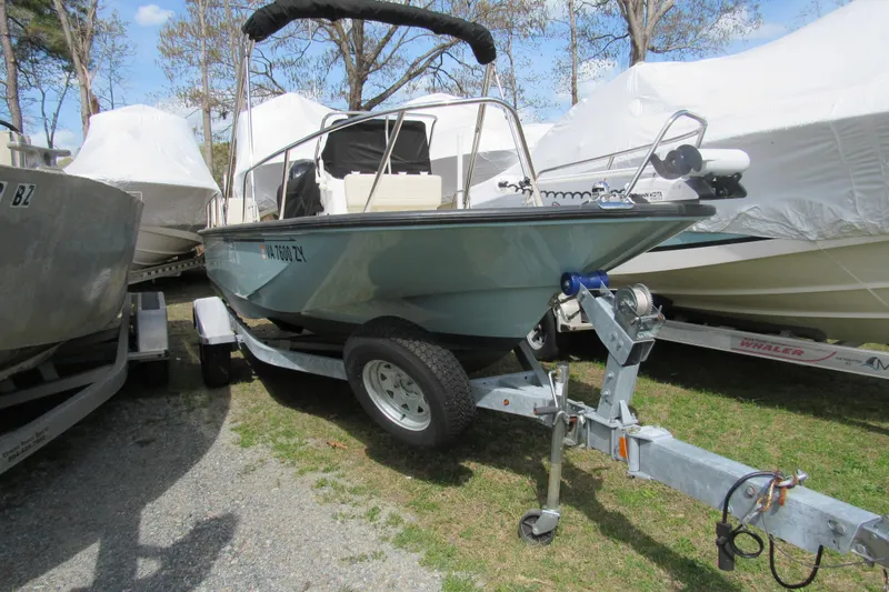 Slide: The Image of 2023 Boston Whaler 170 Montauk boat on trailer, parked outdoors. - 2