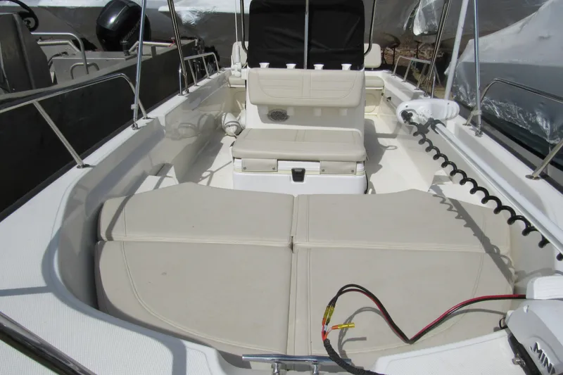 Slide: The Image of 2023 Boston Whaler 170 Montauk interior with seating and storage compartments. - 6