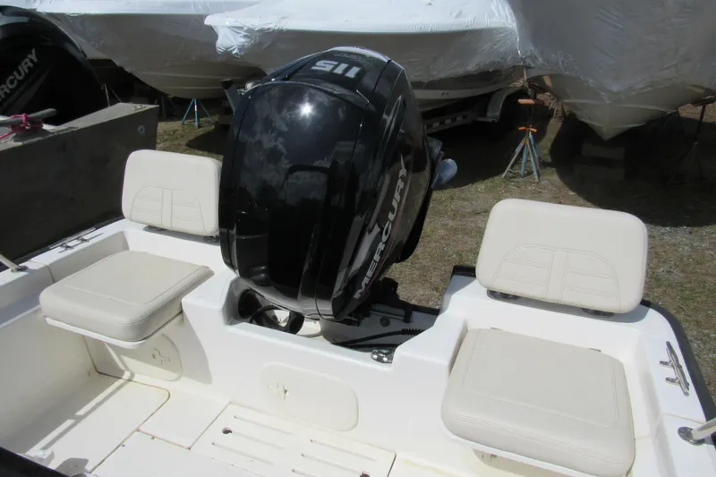 Slide: The Image of 2023 Boston Whaler 170 Montauk boat with Mercury engine and cushioned seating. - 7