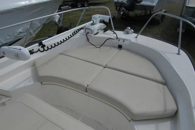 Slide: The Image of 2023 Boston Whaler 170 Montauk boat with cushioned seating and trolling motor. - 8