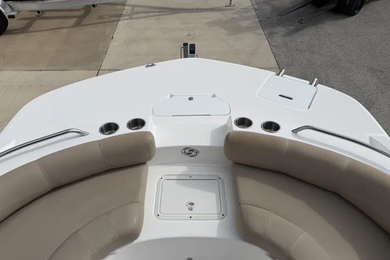 Slide: The Image of 2023 Hurricane SunDeck Sport 201 OB boat interior with beige seating and cup holders. - 13