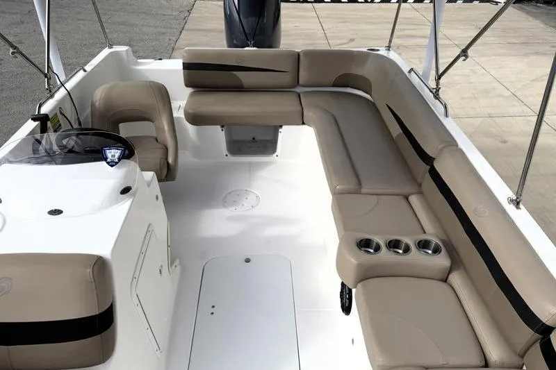 Slide: The Image of 2023 Hurricane SunDeck Sport 201 OB boat interior with beige seating and cup holders. - 15