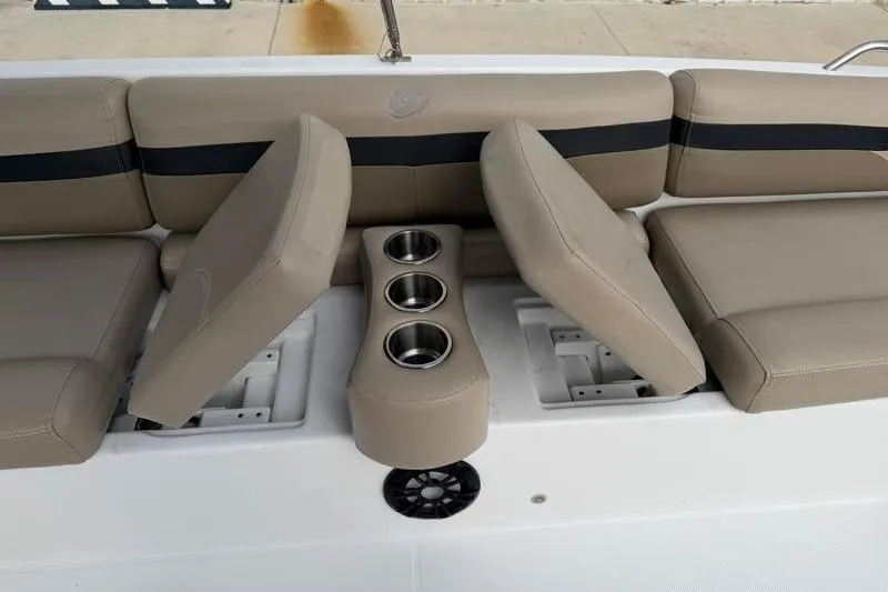 Slide: The Image of 2023 Hurricane SunDeck Sport 201 OB boat seating with cup holders and beige upholstery. - 17