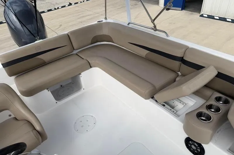 Slide: The Image of 2023 Hurricane SunDeck Sport 201 OB boat interior with beige seating and cup holders. - 18