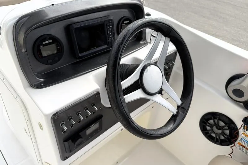 Slide: The Image of 2023 Hurricane SunDeck Sport 201 OB boat dashboard with steering wheel and controls. - 20