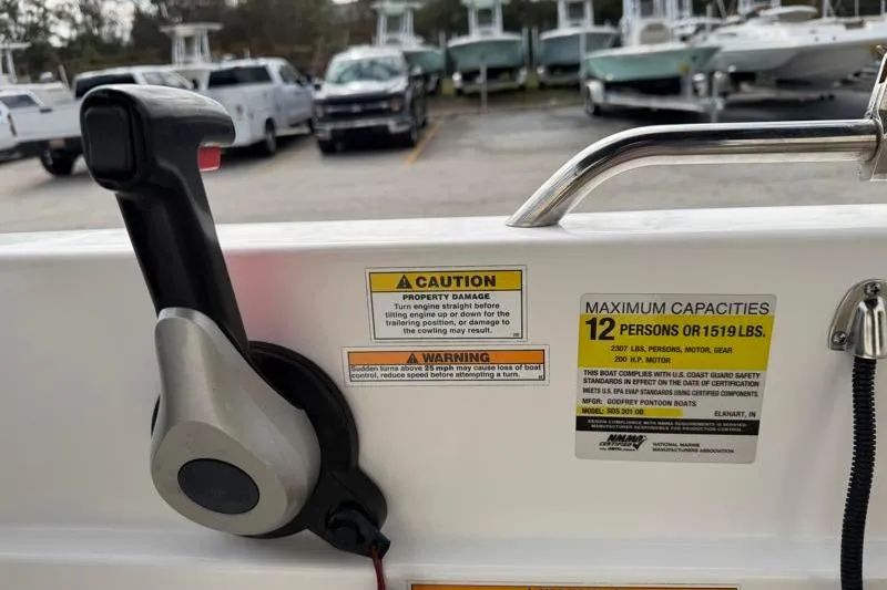 Slide: The Image of 2023 Hurricane SunDeck Sport 201 OB boat controls with capacity warning labels. - 23