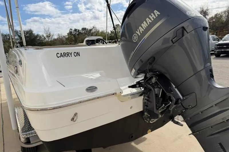 Slide: The Image of 2023 Hurricane SunDeck Sport 201 OB boat with Yamaha outboard motor, labeled "Carry On." - 26