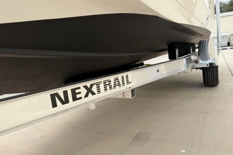 Slide: The Image of 2023 Hurricane SunDeck Sport 201 OB on NexTrail trailer, close-up view. - 30