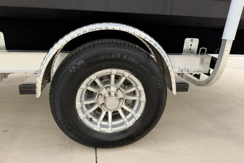 Slide: The Image of Trailer wheel of 2023 Hurricane SunDeck Sport 201 OB boat on pavement. - 31