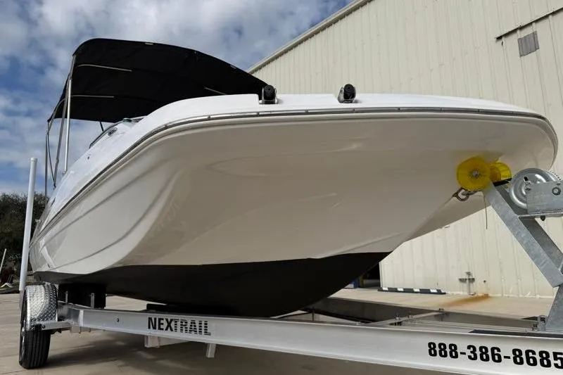 Slide: The Image of 2023 Hurricane SunDeck Sport 201 OB boat on trailer, viewed from front angle. - 7