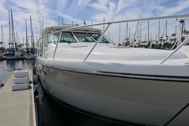 The Image of 2007 Tiara 4200 Open yacht docked at marina with sailboats in background. - 1