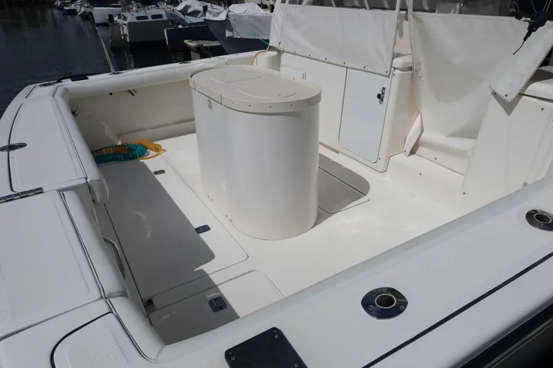 Slide: The Image of 2007 Tiara 4200 Open yacht deck with seating and storage, docked at marina. - 10