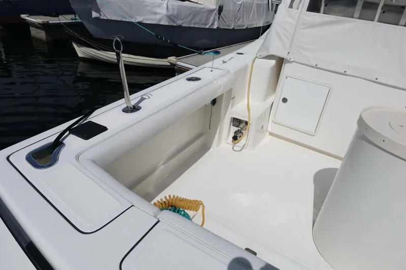 Slide: The Image of 2007 Tiara 4200 Open yacht deck with clean, spacious layout and docked boats nearby. - 14