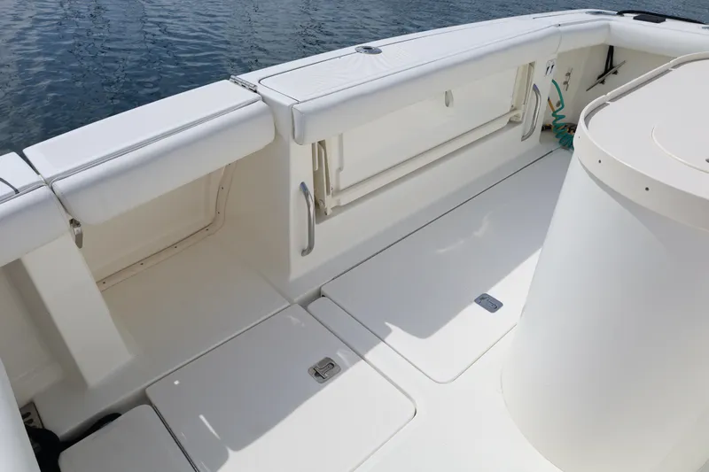 Slide: The Image of 2007 Tiara 4200 Open boat deck with white seating and storage compartments. - 15
