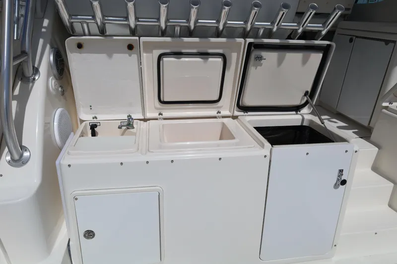 Slide: The Image of 2007 Tiara 4200 Open yacht cockpit with storage compartments and rod holders. - 19