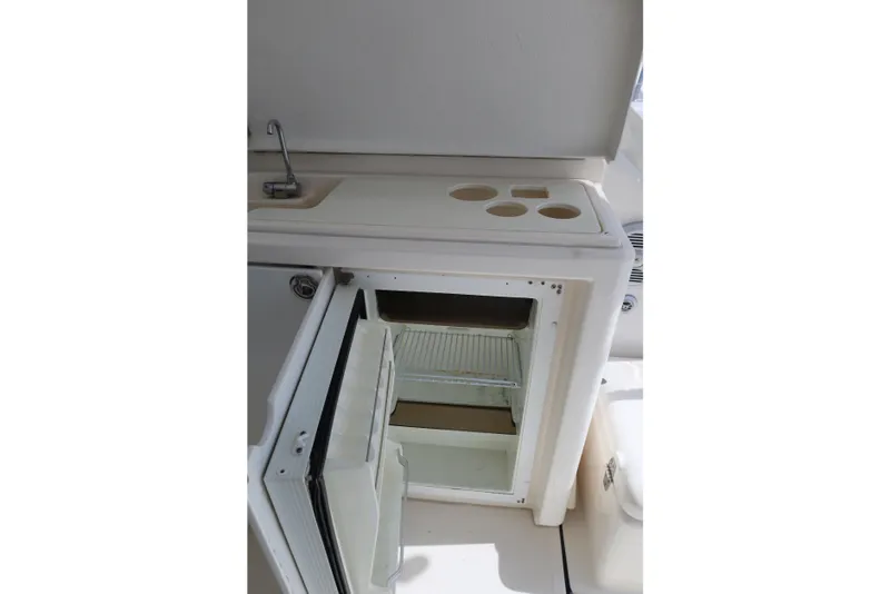 Slide: The Image of 2007 Tiara 4200 Open yacht kitchenette with sink and open mini fridge. - 20