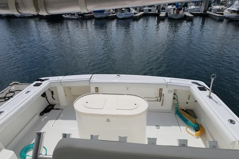 Slide: The Image of 2007 Tiara 4200 Open yacht deck with marina view, featuring spacious seating and storage. - 22