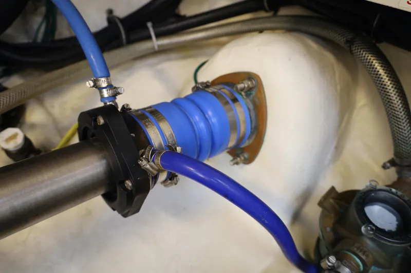Slide: The Image of Engine compartment of a 2007 Tiara 4200 Open, featuring blue hoses and metal fittings. - 25