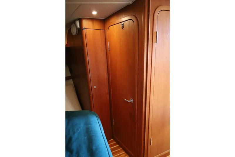 Slide: The Image of Interior of 2007 Tiara 4200 Open yacht with wooden doors and blue bedding. - 30