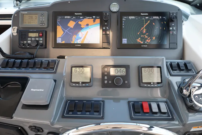 Slide: The Image of Dashboard of a 2005 Tiara Yachts 4200 Open with navigation and control systems. - 32