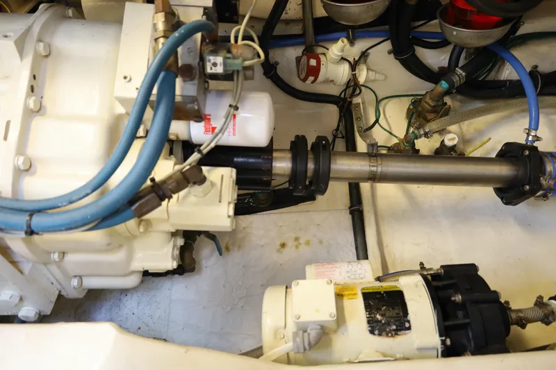 Slide: The Image of Engine compartment of a 2005 Tiara Yachts 4200 Open, showcasing mechanical components and hoses. - 33