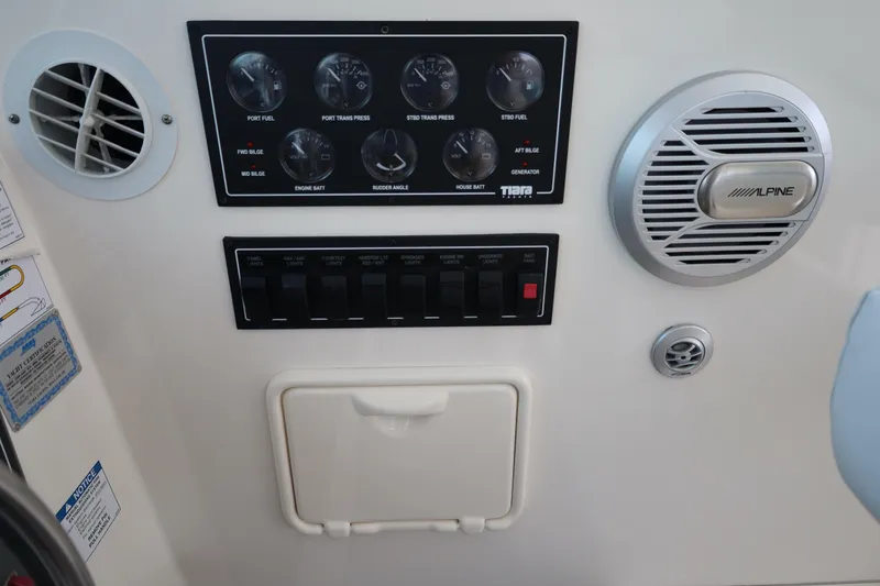 Slide: The Image of Control panel of a 2005 Tiara Yachts 4200 Open with gauges and Alpine speaker. - 37