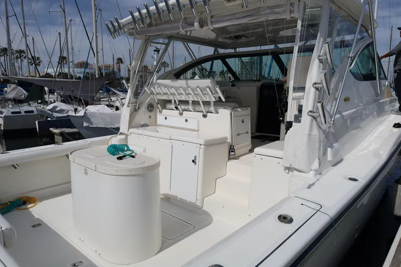 Slide: The Image of 2005 Tiara Yachts 4200 Open, spacious deck, marina background, luxury fishing vessel. - 38