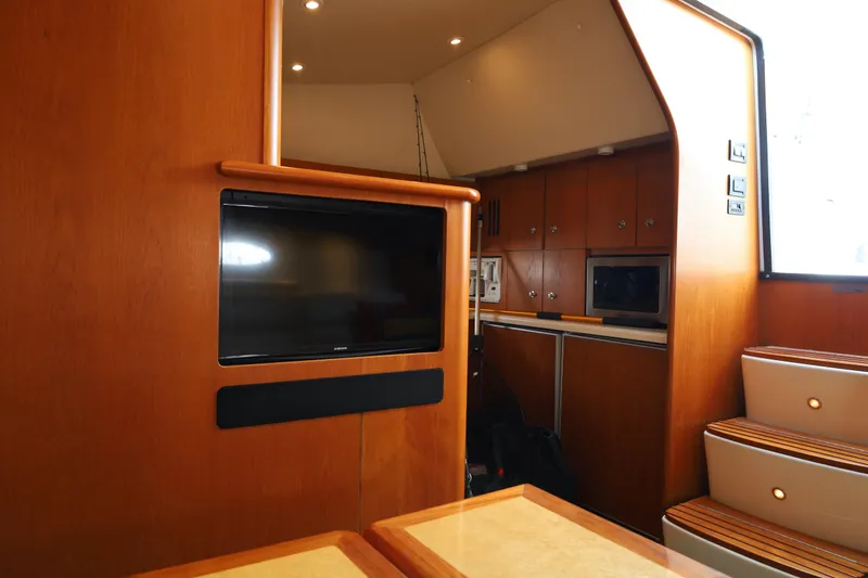 Slide: The Image of Interior of 2005 Tiara Yachts 4200 Open, featuring wood cabinetry and modern amenities. - 39