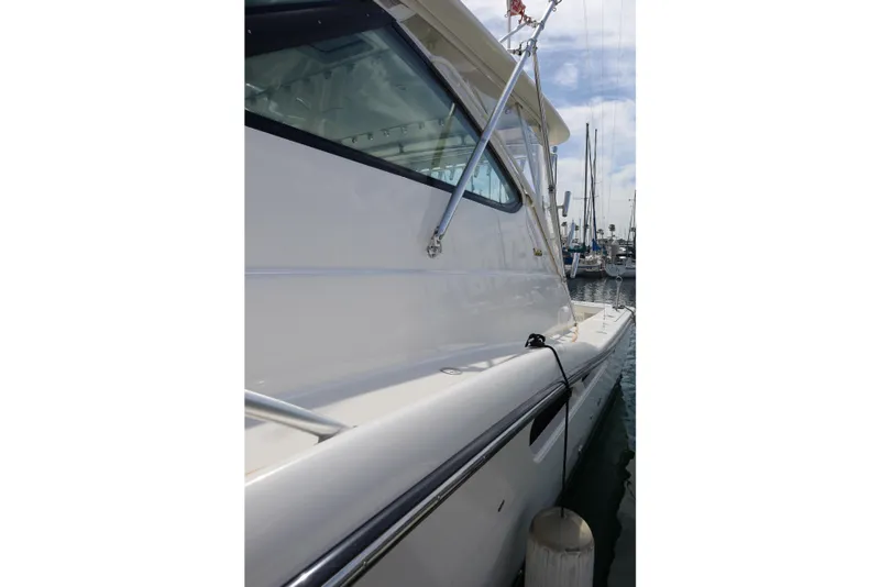 Slide: The Image of Side view of a 2007 Tiara 4200 Open yacht docked at a marina. - 4