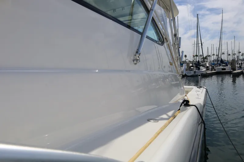 Slide: The Image of Side view of a 2007 Tiara 4200 Open yacht docked at a marina. - 5