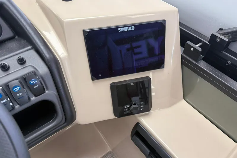 Slide: The Image of Dashboard of 2026 Bentley Pontoons Legacy 243 Swingback with Simrad display and JBL controls. - 10