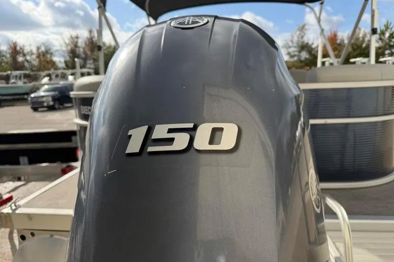 Slide: The Image of 2023 Bennington 22SSR boat with 150 horsepower engine, outdoor setting. - 11