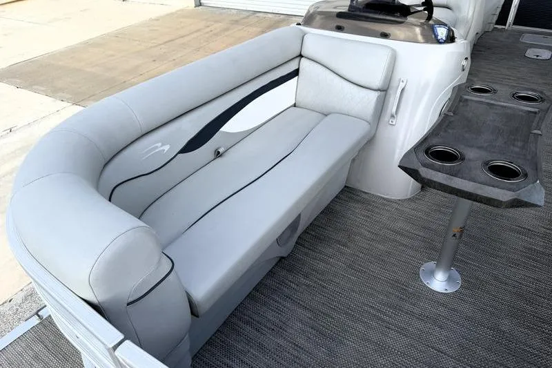 Slide: The Image of 2023 Bennington 22SSR boat interior with gray seating and cupholder table. - 13