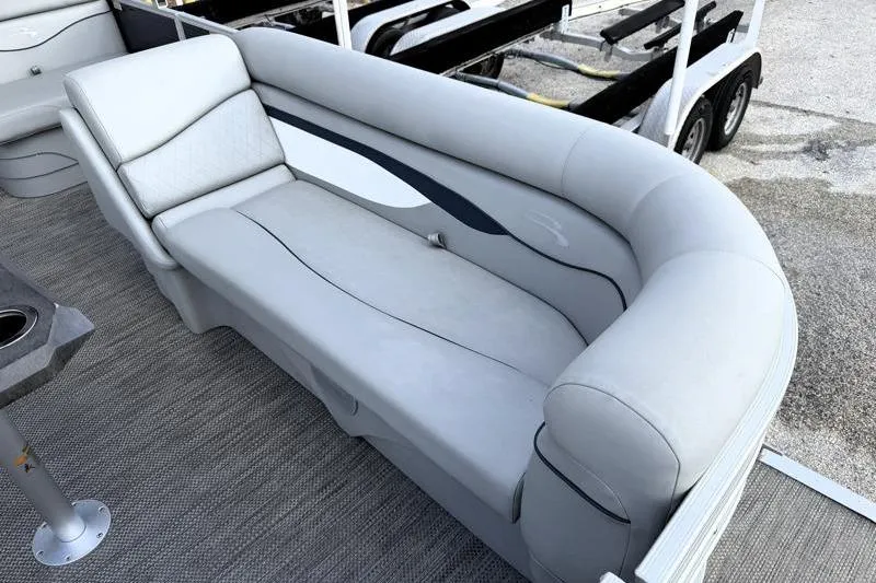 Slide: The Image of 2023 Bennington 22SSR pontoon boat interior with plush gray seating. - 14