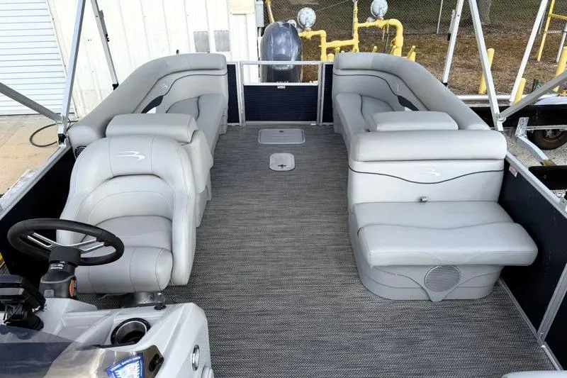 Slide: The Image of 2023 Bennington 22SSR pontoon boat interior with gray seating and steering console. - 16