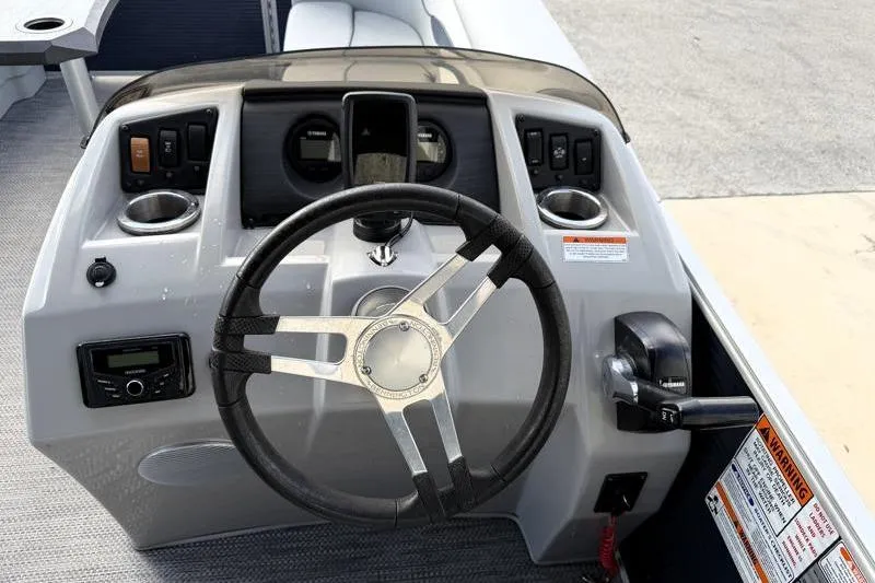 Slide: The Image of 2023 Bennington 22SSR boat dashboard with steering wheel and control panel. - 18