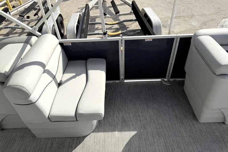 Slide: The Image of 2023 Bennington 22SSR pontoon boat interior with plush seating and carpeted flooring. - 22