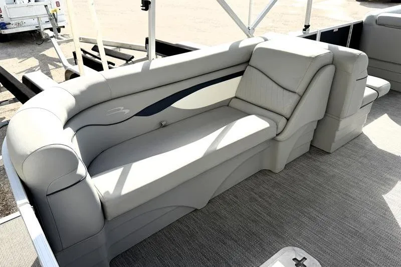 Slide: The Image of 2023 Bennington 22SSR pontoon boat interior with plush seating and modern design. - 24