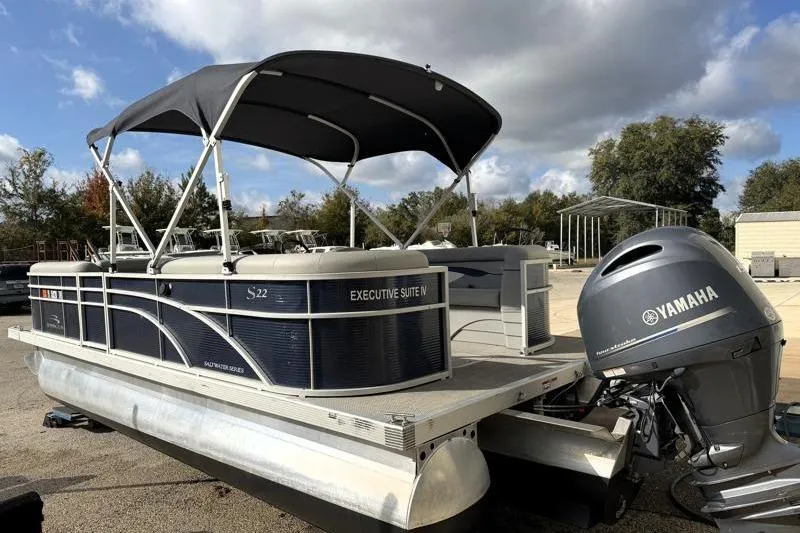 Slide: The Image of 2023 Bennington 22SSR pontoon boat with Yamaha engine, parked outdoors. - 4
